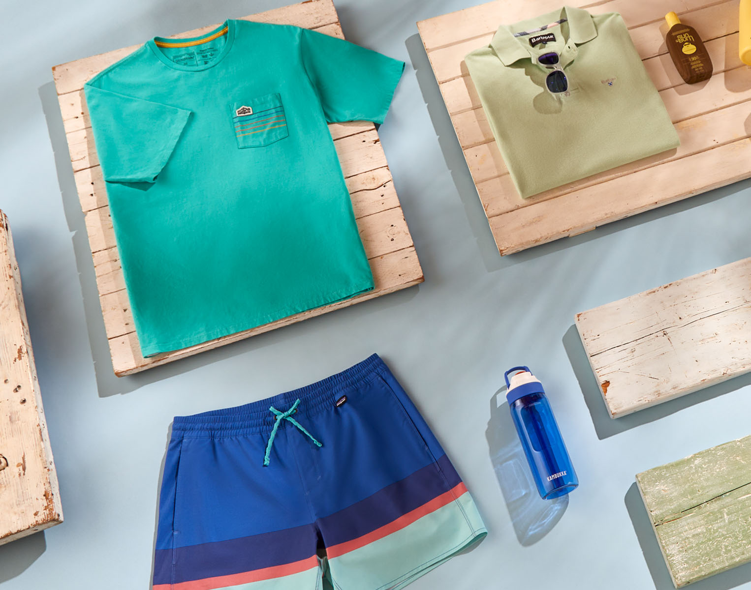 Men's beach clothing, glasses, and a water bottle