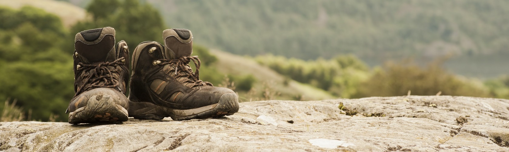 A royalty free stock photo of a pair of walking boots in a country setting.-
