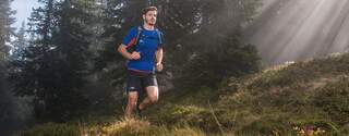 Man running through forest
