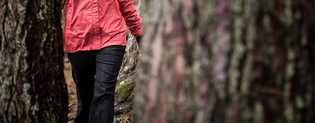 A person wearing waterproof trousers in the woods 
