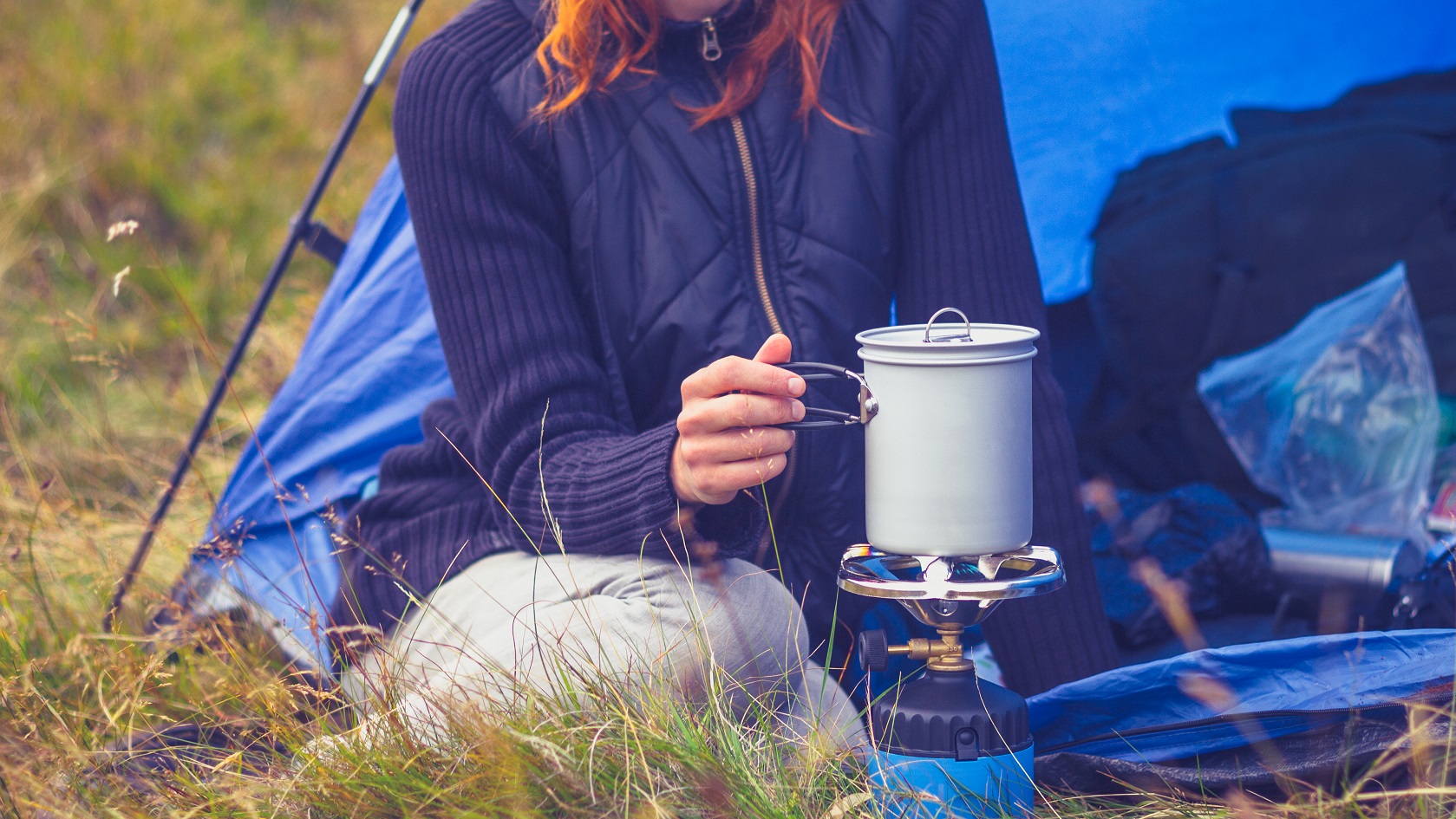 Woman warming her food in a stove
