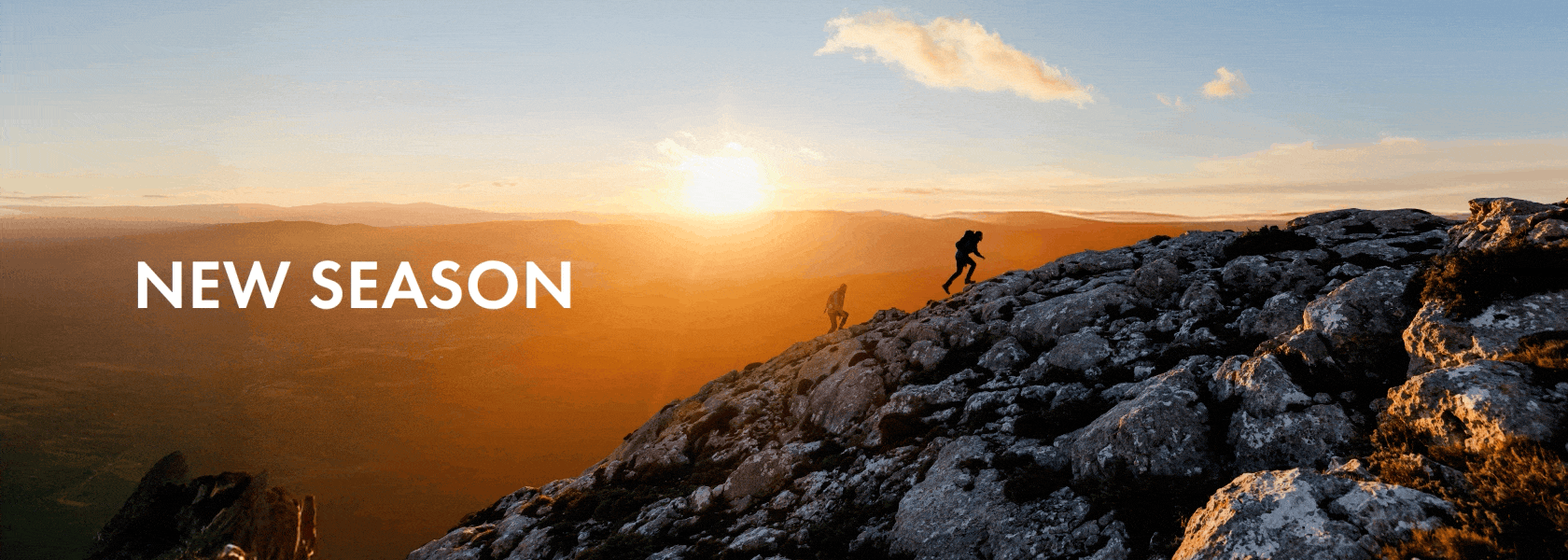 Fresh Territory. New Season. Woman and man climbing a mountain at sunrise
