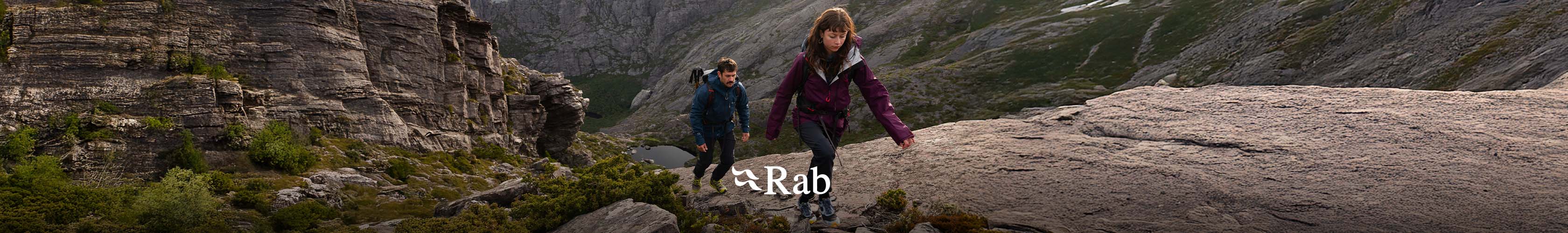 rab. two people walking up a mountain