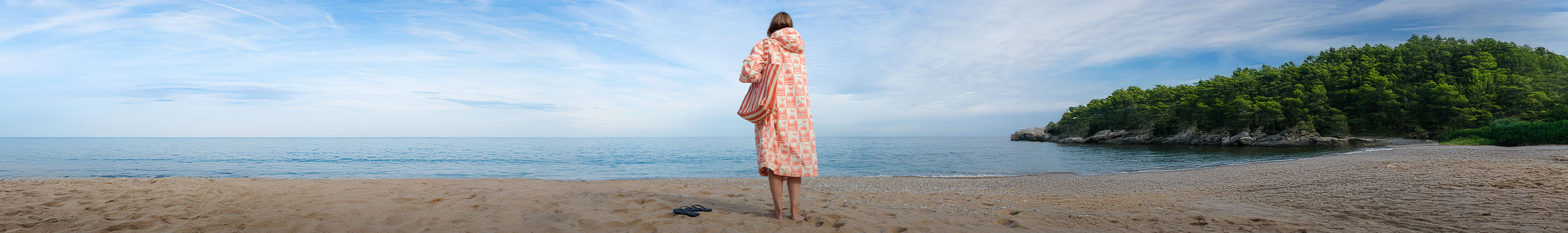 summertime - someone by the sea wearing a dry robe