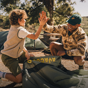camping - two people putting up a tent