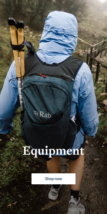 Women walking in the mountains with hiking poles and backpack