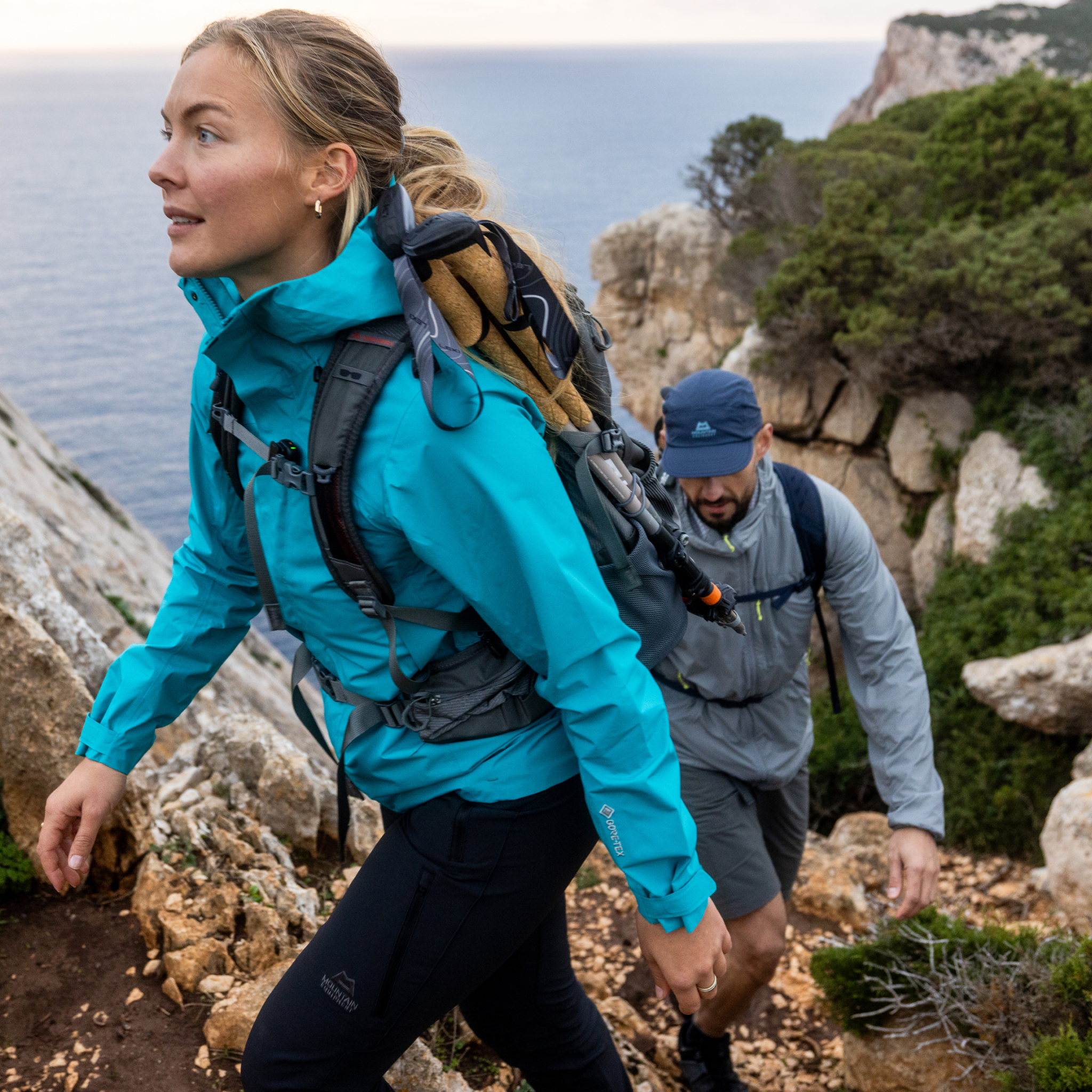 two backpackers climbing