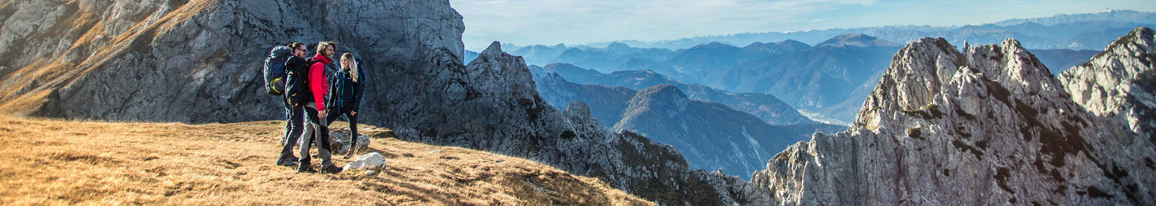 People standing on a mountain wearing and carrying DofE recommended kit.