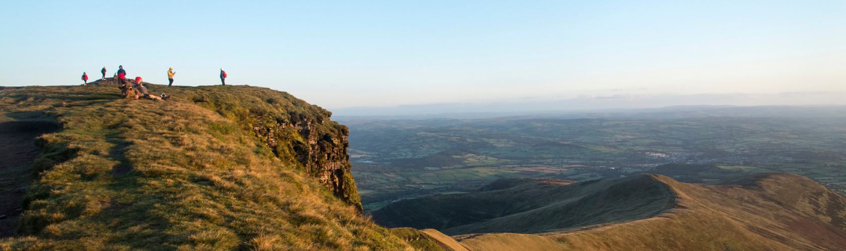 An image of people standing on a hill top