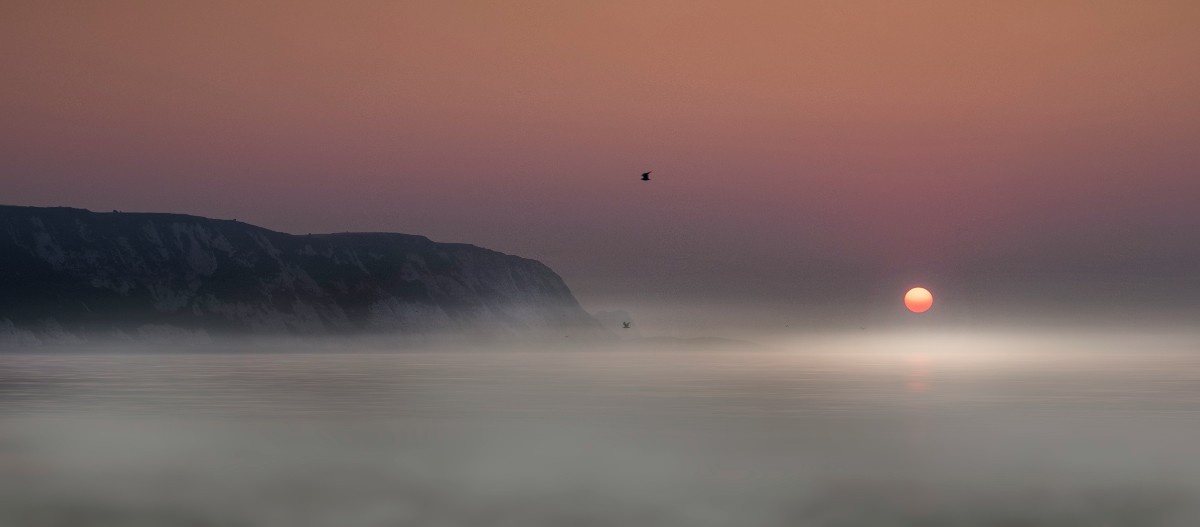 The sun rising over Folkestone beach 