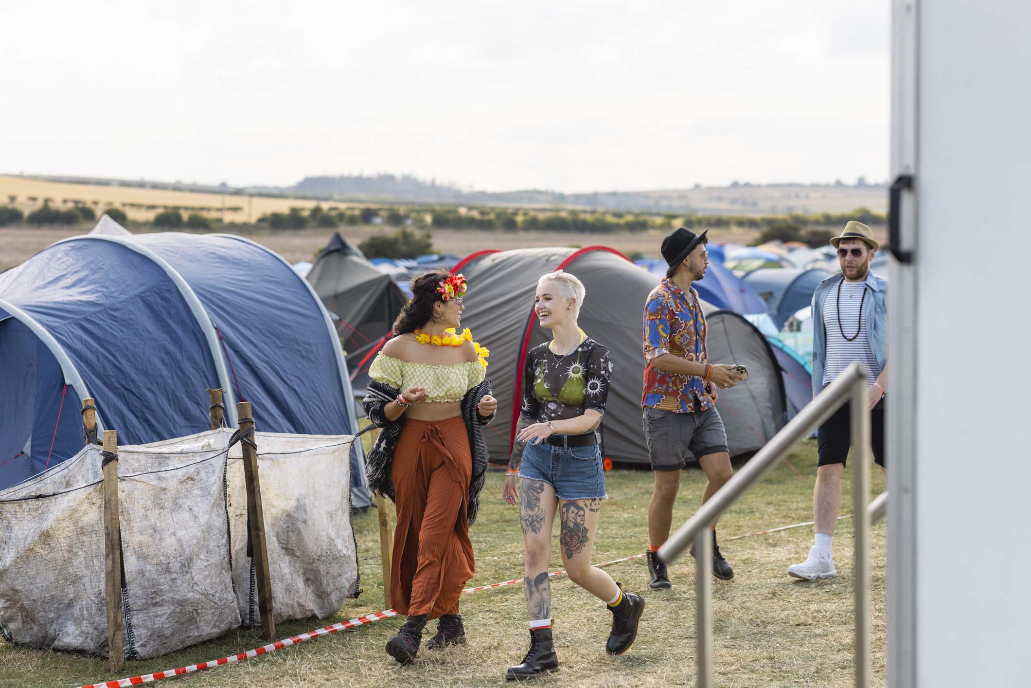 Some people walking to the Latitude Festival music arena