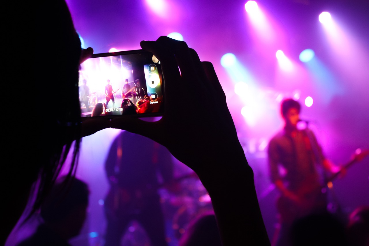 A person taking a photo of a performer at Latitude Festival 