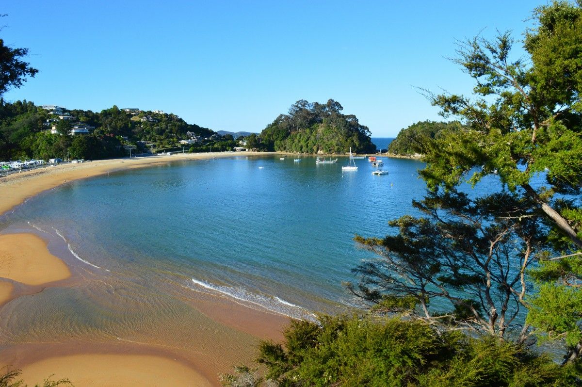 A gorgeous blue lake and beach at the Abel Tasman National Park