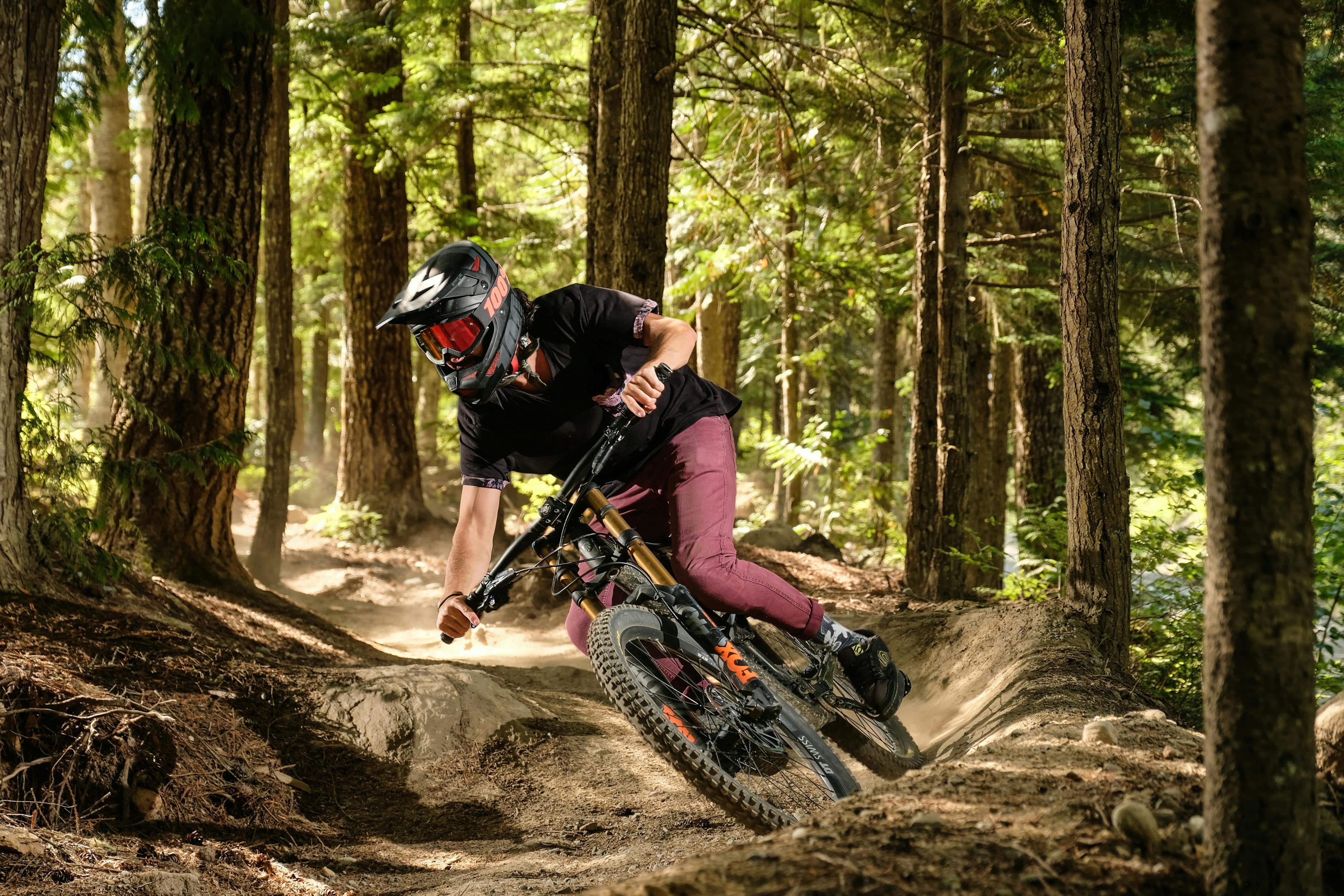 A person mountain biking through the forest 