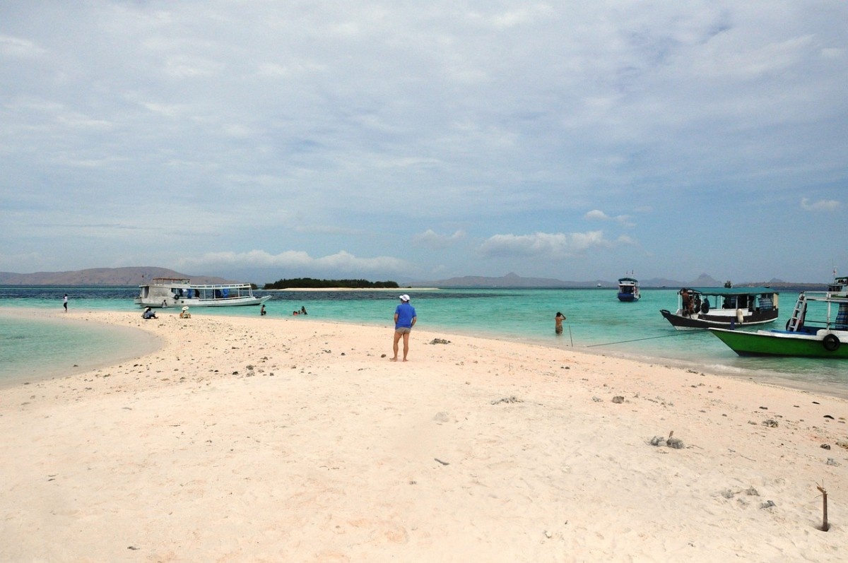 People on a strip of beach in Komodo National Park 