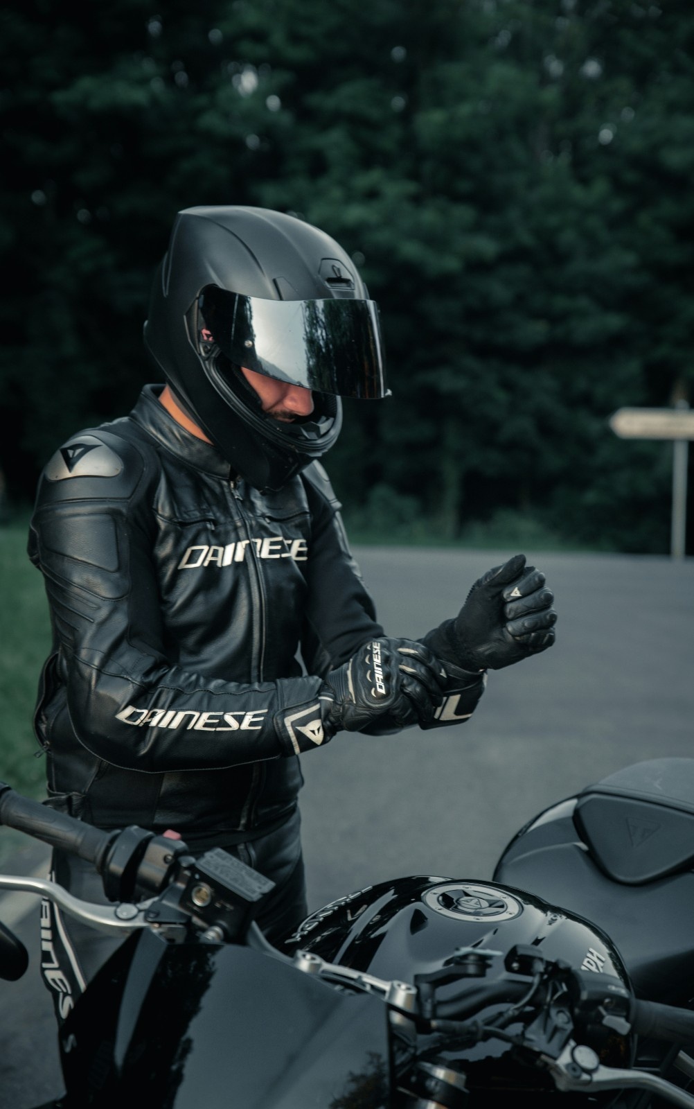 A man in bike leathers wearing leather biking gloves