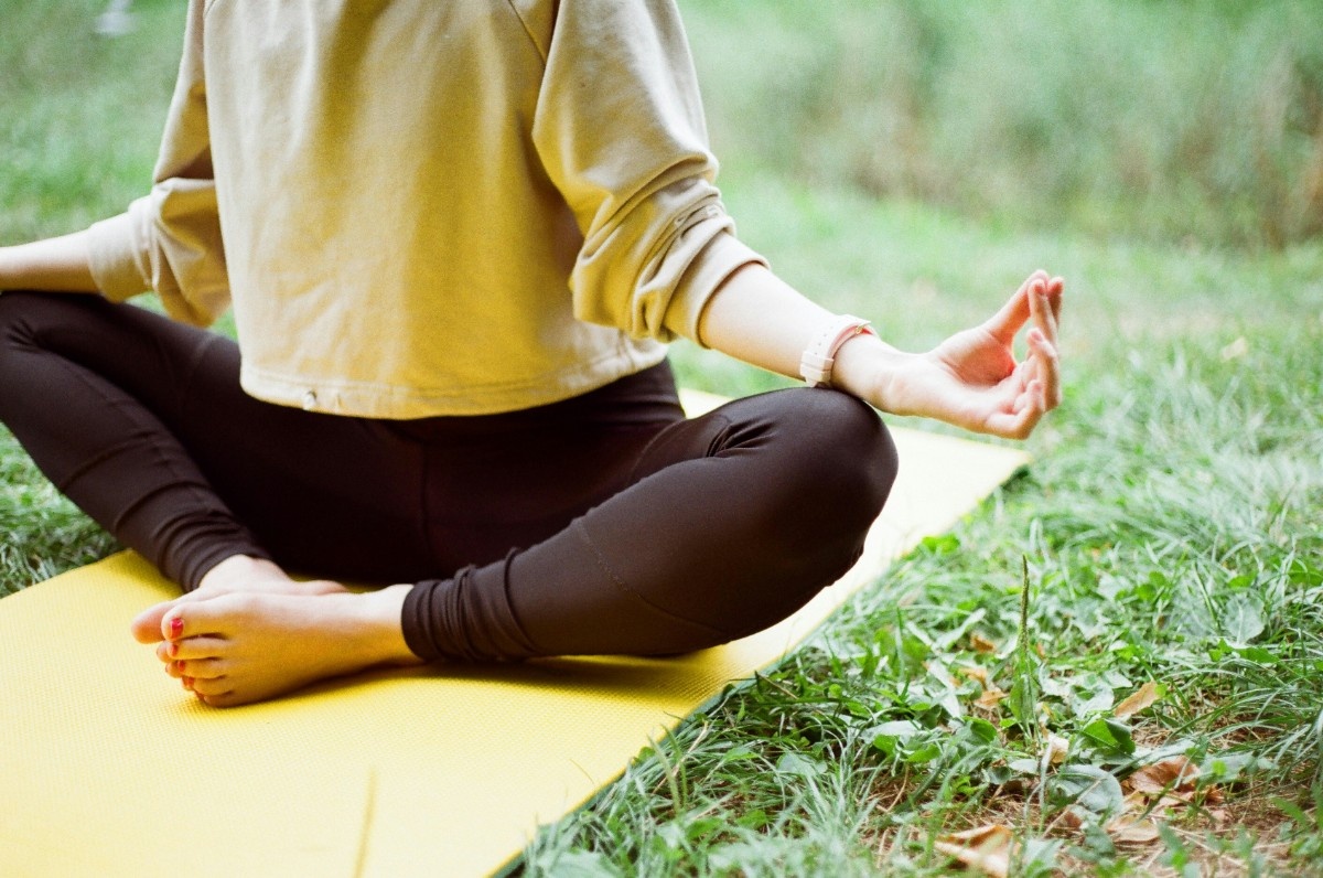 A woman in a yoga pose outside 