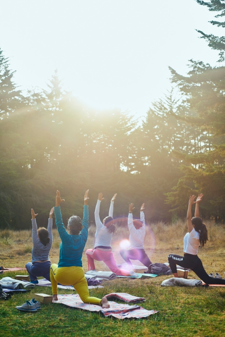 A group of people doing outdoor yoga