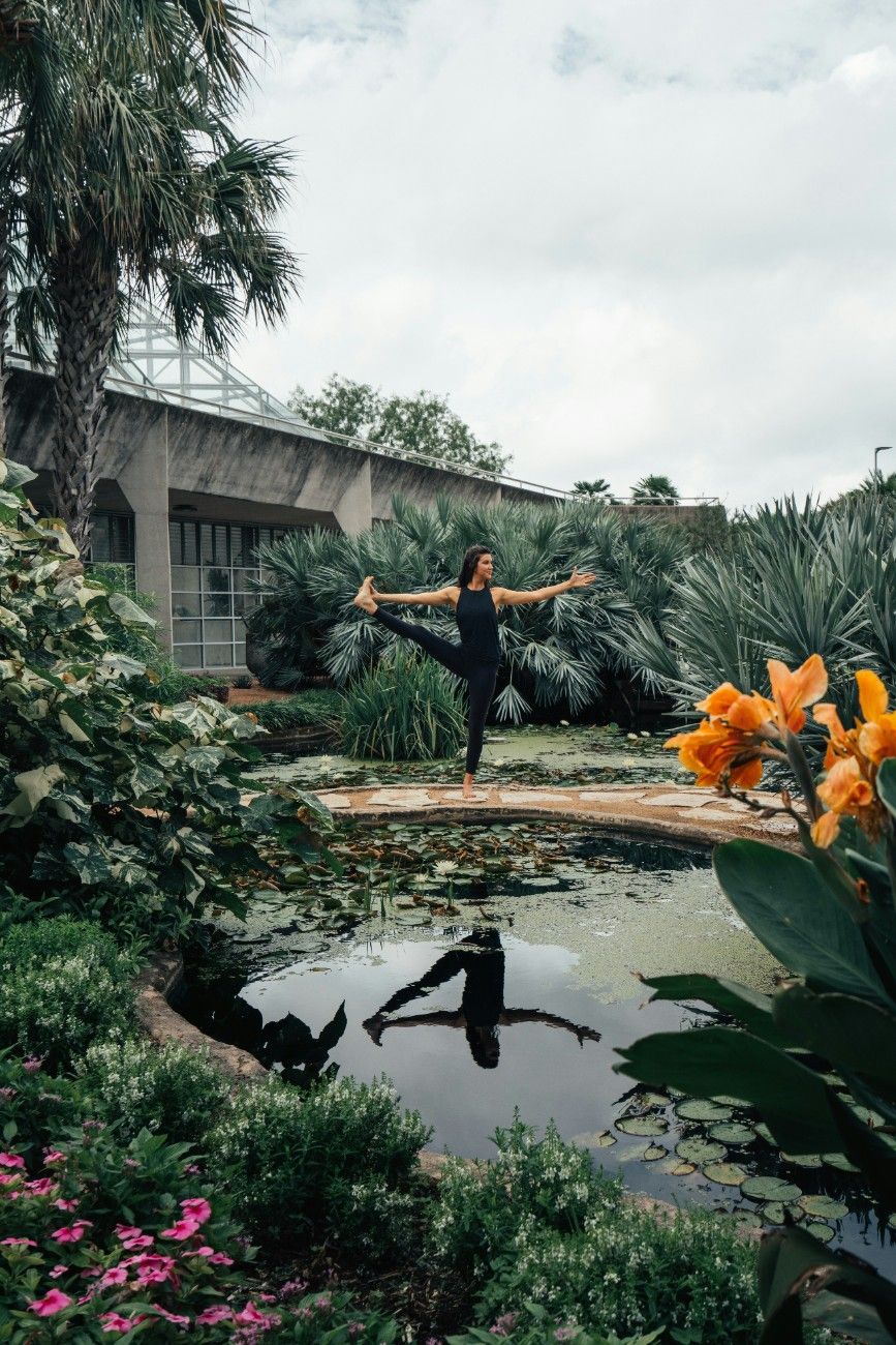 A woman doing a yoga pose outside 