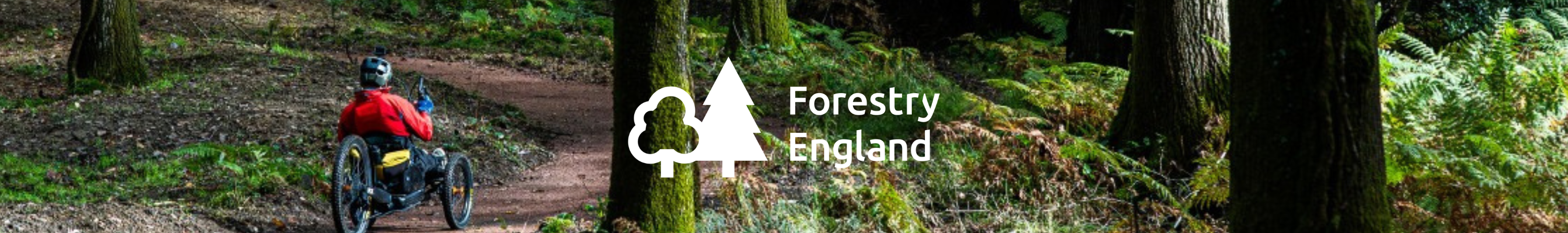 A couple with two children are walking next to one of the National Trust houses. 