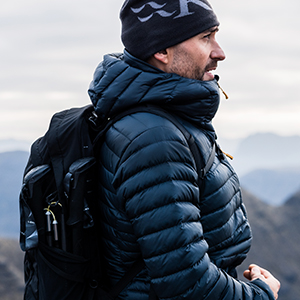 Shop men's outdoor gear. A man wearing a down jacket on a hike