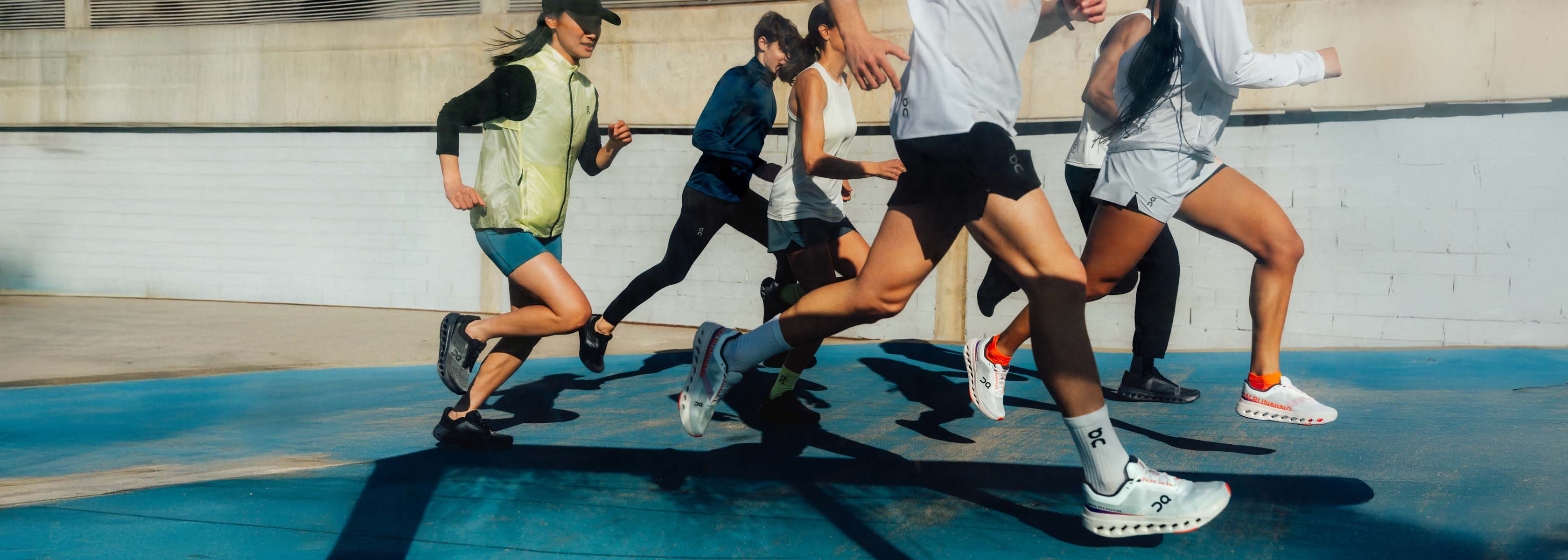 Shop Hoka Clifton. A group of runners on the street