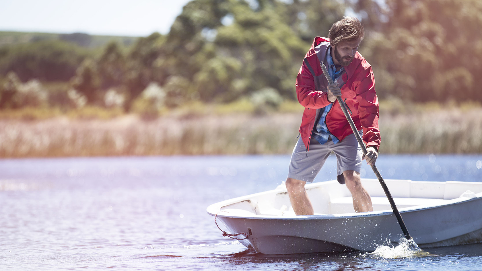 A man in a canoe wearing a waterproof jacket 