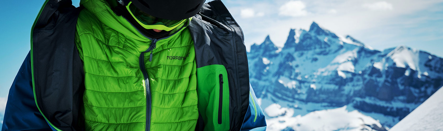 An image of a person zipping up their insulated jacket