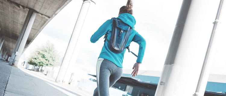 A woman wearing a running pack