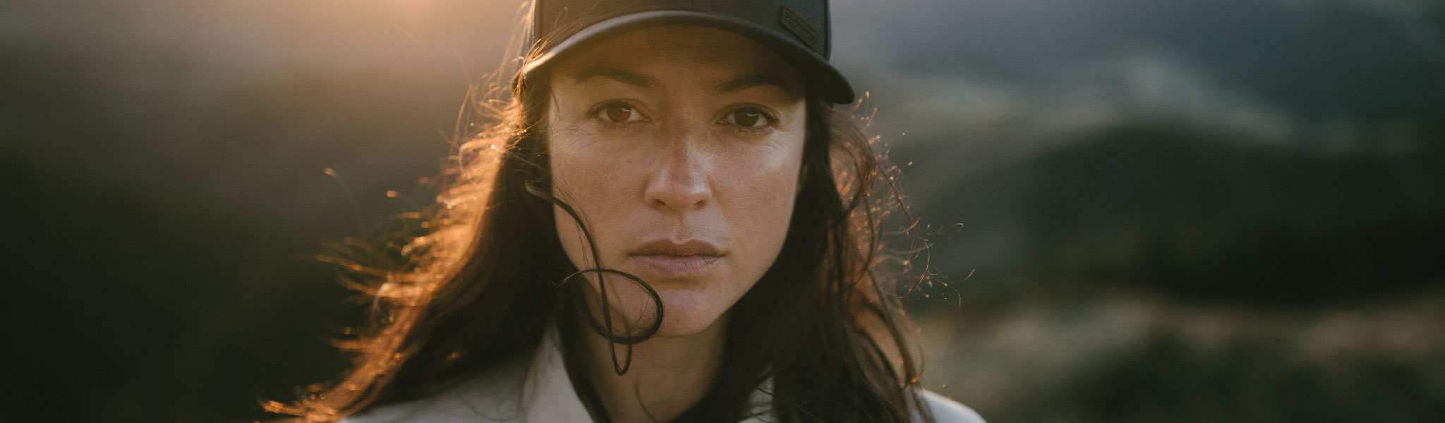 A woman wearing a Mountain Equipment jacket and helmet climbing