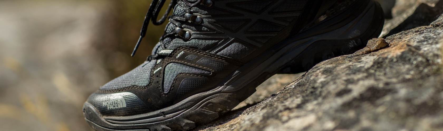 A person wearing walking shoes in the woods