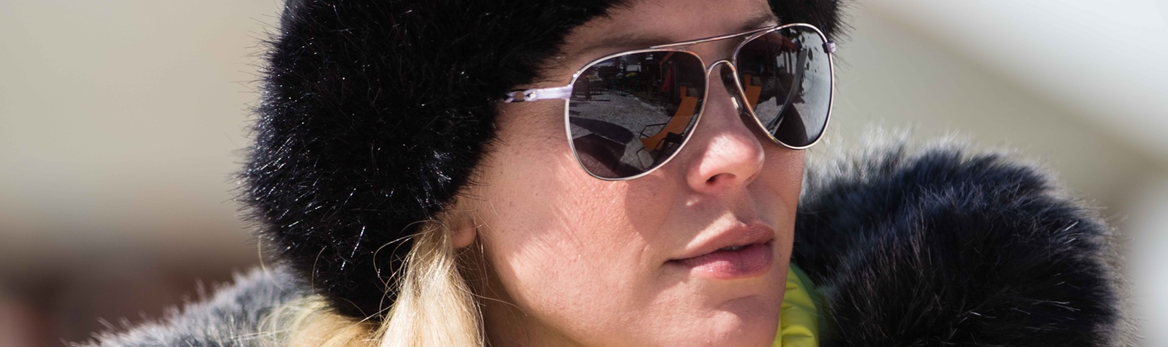 A woman wearing sunglasses in the snow 